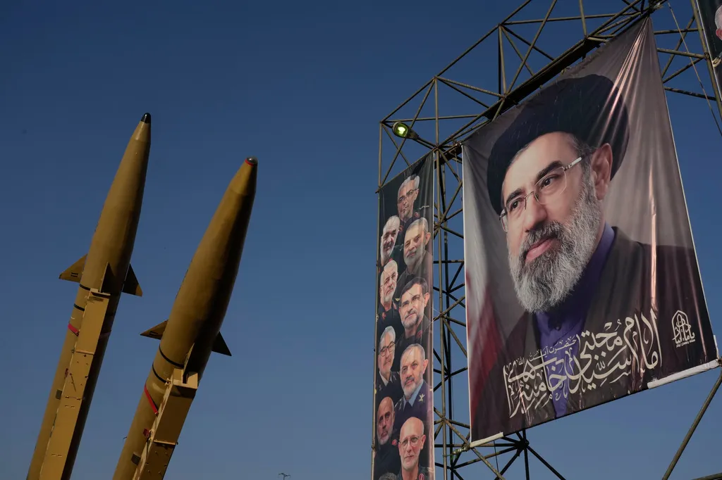 Iranian missiles and banners showing portraits of the Iranian Supreme Leader Ayatollah Mojtaba Khamenei, right, and the late armed forces commanders, who were killed in Israeli and U.S. strikes, are displayed in a military exhibition commemorating the anniversary of the start of the 1980-88 Iraq-Iran war at Baharestan Square, in Tehran, Monday, Sept. 28, 2026. (AP Photo/Vahid Salemi)