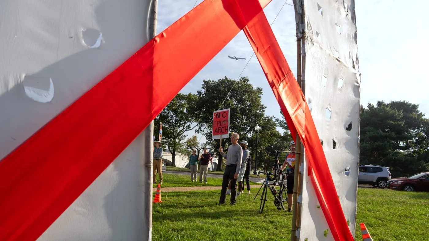 Demonstrators gather near an anti-arch structure at Memorial Circle to protest the proposed triumphal arch, Oct. 1, 2026, in Arlington, Va.