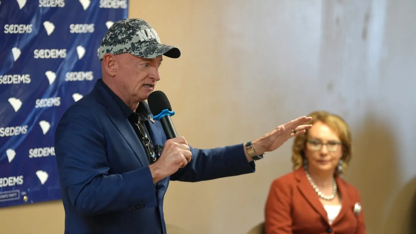 Sen. Mark Kelly, D-Ariz., speaks to a group of South Carolina Democrats ahead of the 2026 midterm elections as his wife, former Rep. Gabby Giffords, D-Ariz., looks on, Friday, Oct. 2, 2026, in Mauldin, S.C. (AP Photo/Meg Kinnard)