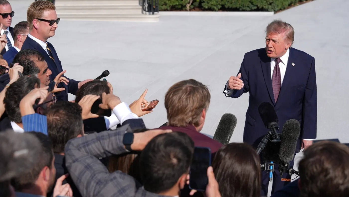 President Trump speaks with reporters before boarding Marine One on the South Lawn of the White House, Oct. 2, 2026, in Washington.