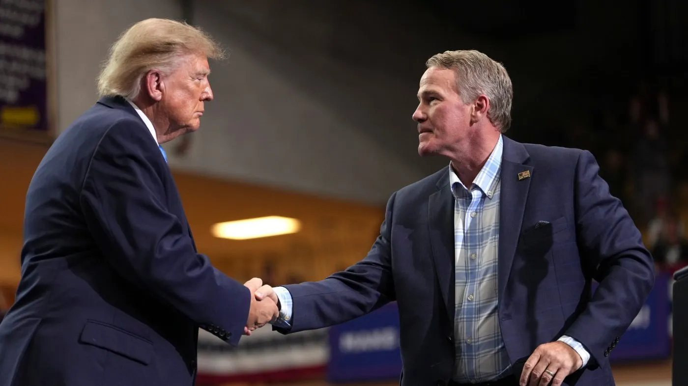 Sen. Jon Husted, R-Ohio, right, shakes the hand of President Donald Trump after speaking during an event at Butler High School in Vandalia, Ohio, Saturday, Oct. 3, 2026. (AP Photo/Mark Schiefelbein)