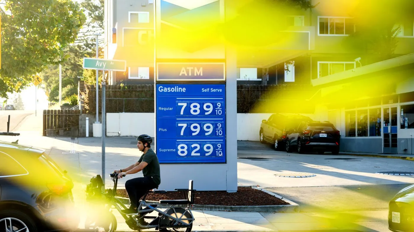 A biker passes a marquee displaying gas prices at a Menlo Park, Calif., Chevron station on Oct. 5, 2026.