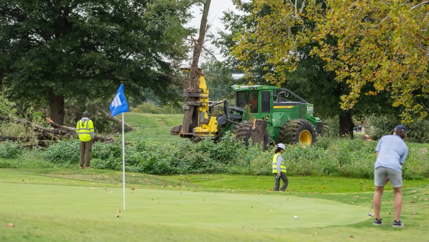 A golfer putts as workers at the National Park Service begin cutting down trees at East Potomac Golf Links on Oct. 10, 2026, in Washington.