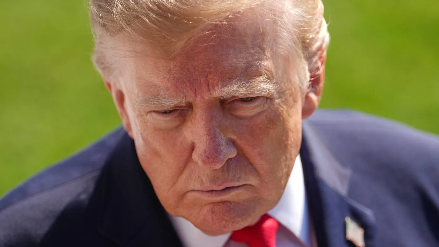 President Trump speaks to the reporters as he walks to board Marine One on the South Lawn of the White House on Oct. 13, 2026, in Washington.