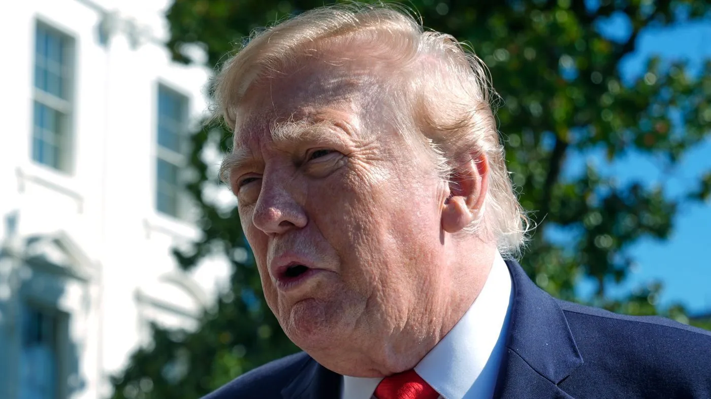 President Donald Trump talks to reporters before boarding Marine One on the South Lawn of the White House, Tuesday, Oct. 13, 2026, in Washington. (AP Photo/Manuel Balce Ceneta)