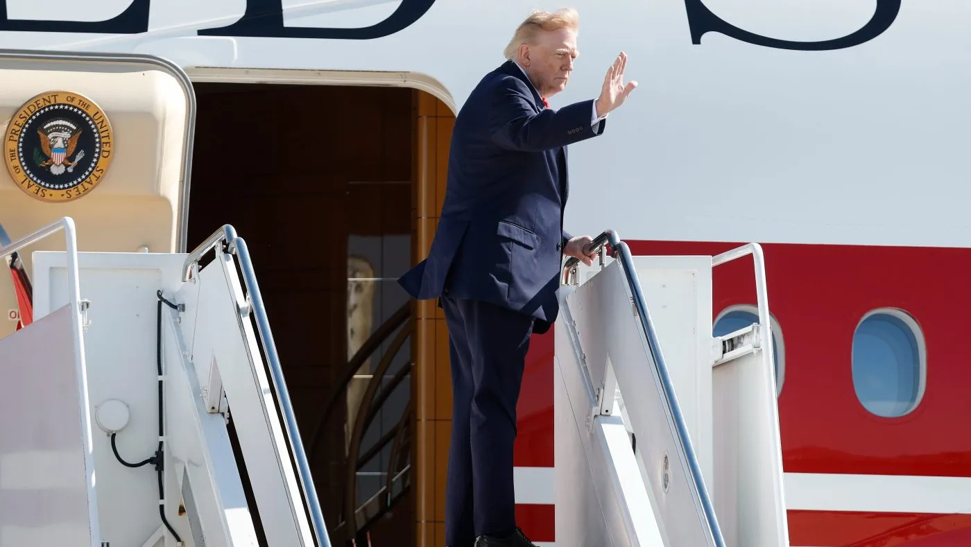 President Donald Trump waves from the stairs of Air Force One at Joint Base Andrews, Md., Tuesday, Oct. 13, 2026. (AP Photo/Luis M. Alvarez)