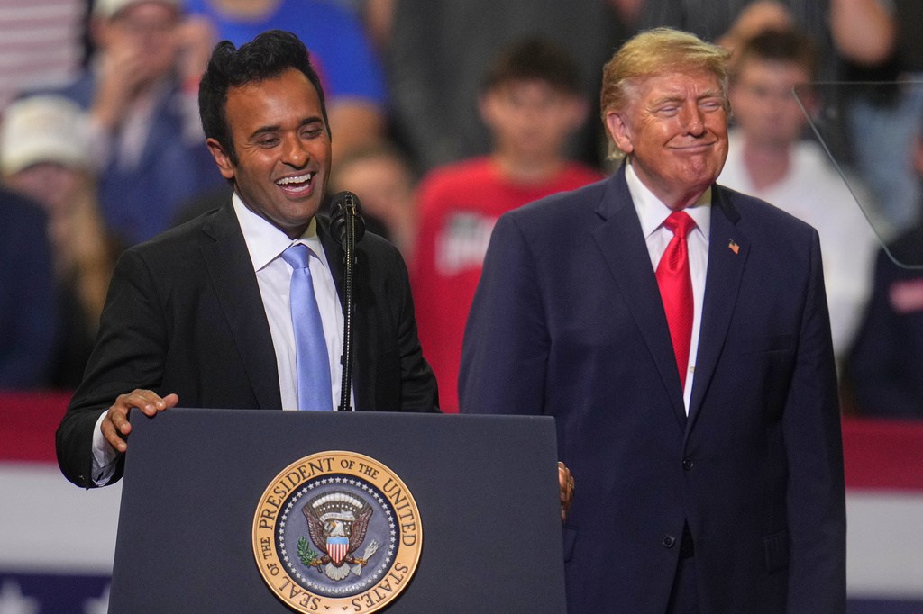 President Donald Trump listens a gubernatorial candidate Vivek Ramaswamy speaks at a campaign rally at the Covelli Centre, in Youngstown, Ohio, Monday, Oct. 12, 2026. (AP Photo/Gene J. Puskar)