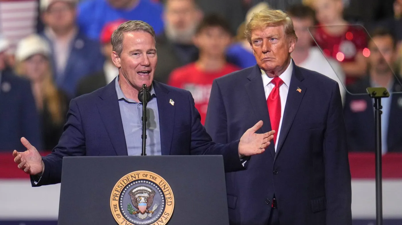 President Trump listens as Sen. Jon Husted (R-Ohio) speaks at a campaign rally at the Covelli Centre, in Youngstown, Ohio, Oct. 12, 2026.