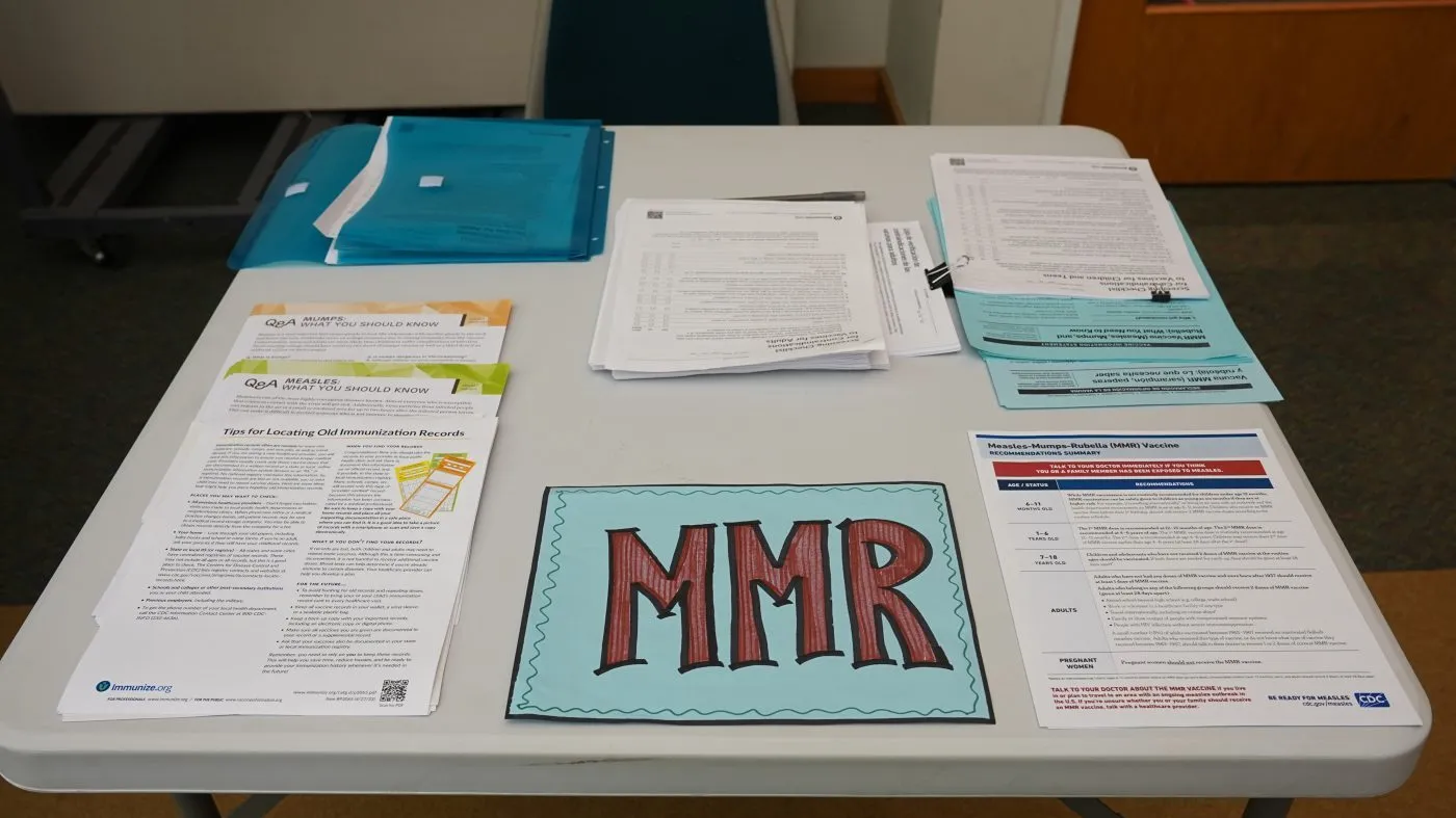 Materials sit on the check-in desk for the combination measles, mumps and rubella vaccine at the Montgomery County Office of Public Health Upper Merion Township Community Clinic in King of Prussia, Pa., Monday, Oct. 19, 2026.