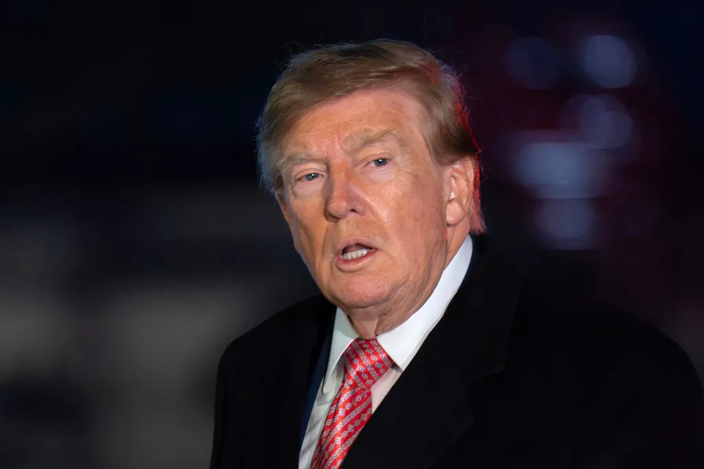 President Donald Trump talks to reporters as he walks on the South Lawn upon his arrival to the White House, Sunday, Oct. 18, 2026, in Washington. (AP Photo/Jose Luis Magana)