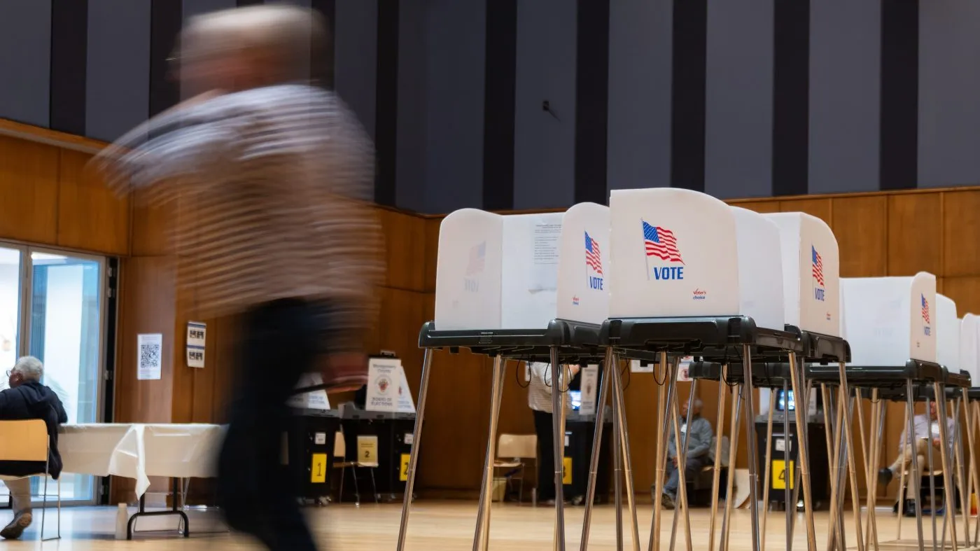 A person walks past voting booths at the Silver Spring Civic Building for the first day of early voting in the 2026 midterm race, Oct. 22, 2026, in Silver Spring, Md.