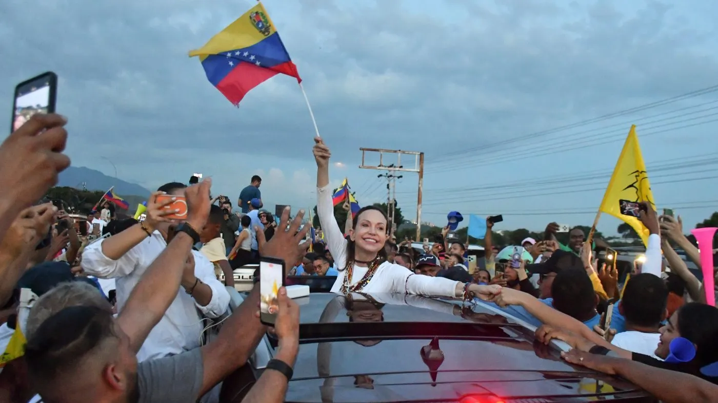 Supporters surround Venezuelan opposition leader and Nobel Peace Prize laureate Maria Corina Machado in Valencia, Venezuela, following her return to the country after months abroad, Sunday, Oct. 25, 2026. (AP Photo/Jacinto Oliveros)