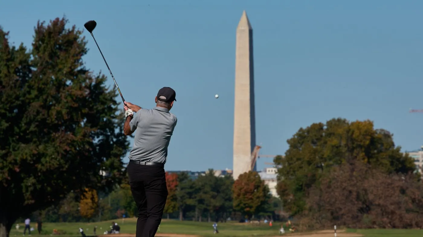The Washington Monument is seen as a golfer takes a swing at East Potomac Park Golf Course, Oct. 26, 2026, in Washington.
