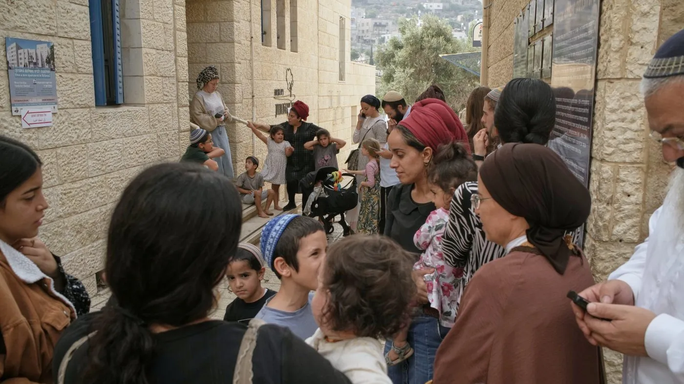 Israeli settlers gather with their children outside a polling station during Israel’s general election in Hebron in the occupied West Bank on Oct. 27, 2026.