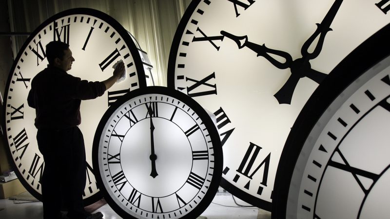 Electric Time Co. employee Walter Rodriguez cleans the face of an 84-inch Wegman clock at the plant in Medfield, Mass. Thursday, Oct. 30, 2008. (AP Photo/Elise Amendola)