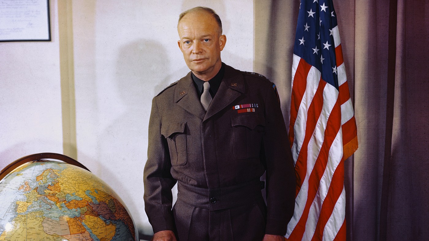 Dwight D. Eisenhower is shown in a portrait, standing near globe.