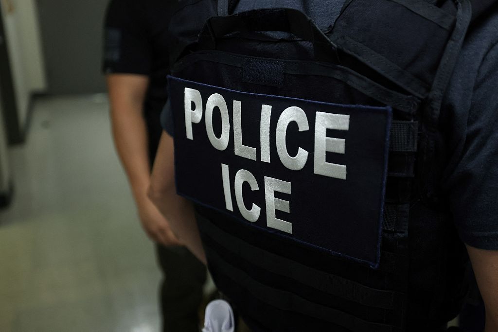 An agent of Immigration and Customs Enforcement (ICE) waits in a hallway outside of a courtroom at New York Federal Plaza Immigration Court inside the Jacob K. Javitz Federal Building in New York on July 17, 2025. US President Donald Trump has made deporting undocumented immigrants a key priority for his second term, after successfully campaigning against an alleged “invasion” by criminals. (Photo by CHARLY TRIBALLEAU / AFP) (Photo by CHARLY TRIBALLEAU/AFP via Getty Images)