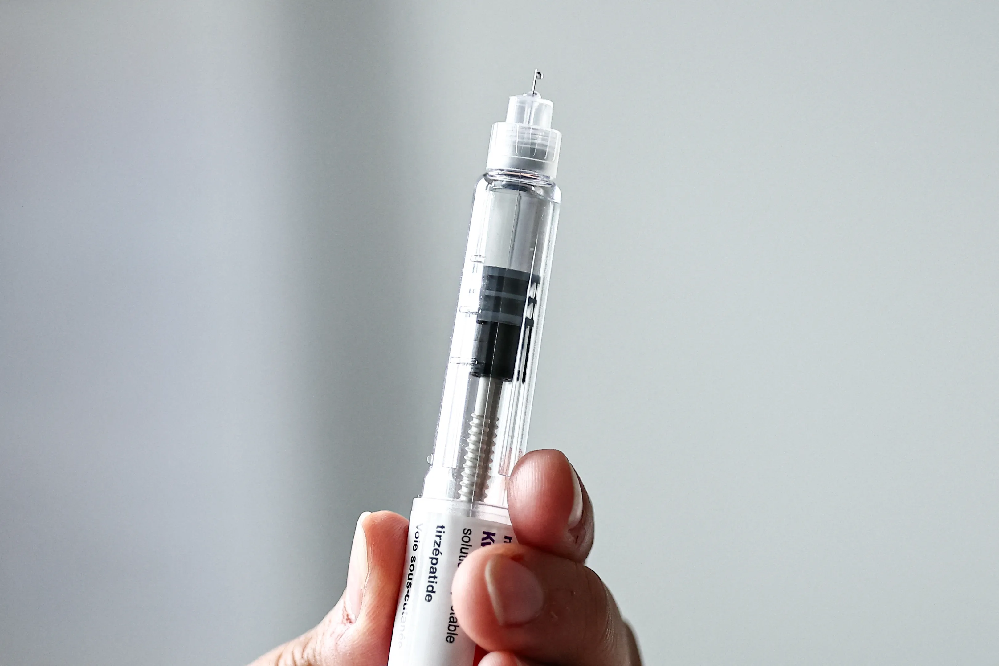 This photograph shows a KwikPen of the drug Mounjaro, containing the active ingredient tirzepatide, used in the treatment of obesity, at the Valenciennes Hospital Centre (Centre Hospitalier de Valenciennes) in Valenciennes, northern France on June 12, 2026. Virginie hopes she’s on the brink of “a life change”: starting on June 15, 2026, many patients like her will be able to access Mounjaro and Wegovy, two anti-obesity medications that are now reimbursed, and requests are already pouring in at the specialized center in Valenciennes, northern France. (Photo by Sameer Al-DOUMY / AFP via Getty Images)