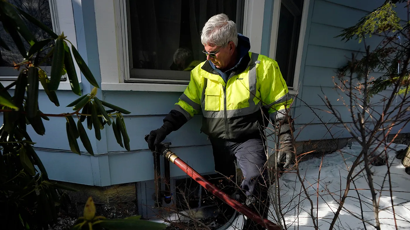 Peter Ellingwood, of Bob’s Cash Energy, delivers heating oil, Jan. 31, 2023, in Farmington, Maine.