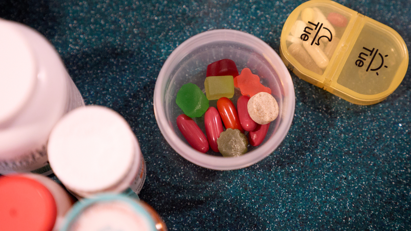 Tracy Rand takes her morning medications and supplements to help with her severe menopause symptoms, brought on after a surgery to remove her ovaries, at her home in Leesburg, Fla., Friday, Aug. 14, 2026. (AP Photo/Jacquelyn Martin)