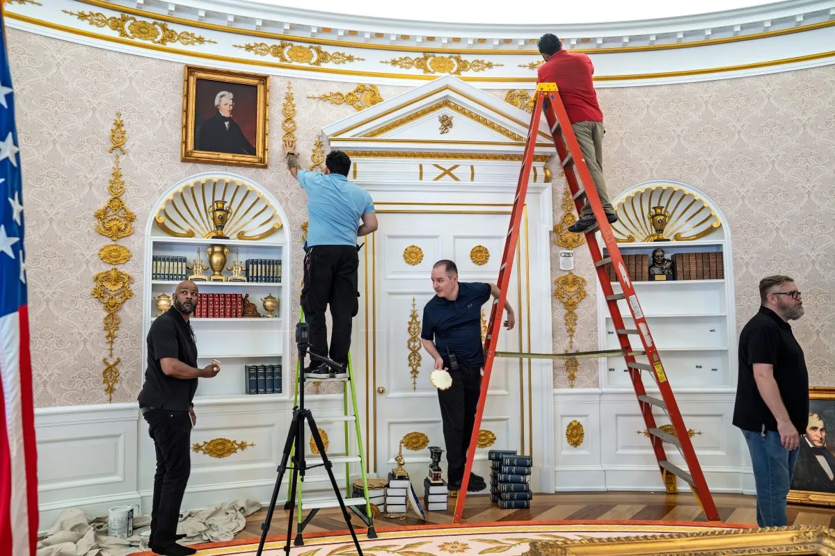 A replica of President Donald Trump’s Oval Office is updated to the current decor by workers at “The People’s House: A White House Experience,” in Washington, Friday, Oct. 2, 2026. (AP Photo/J. Scott Applewhite)