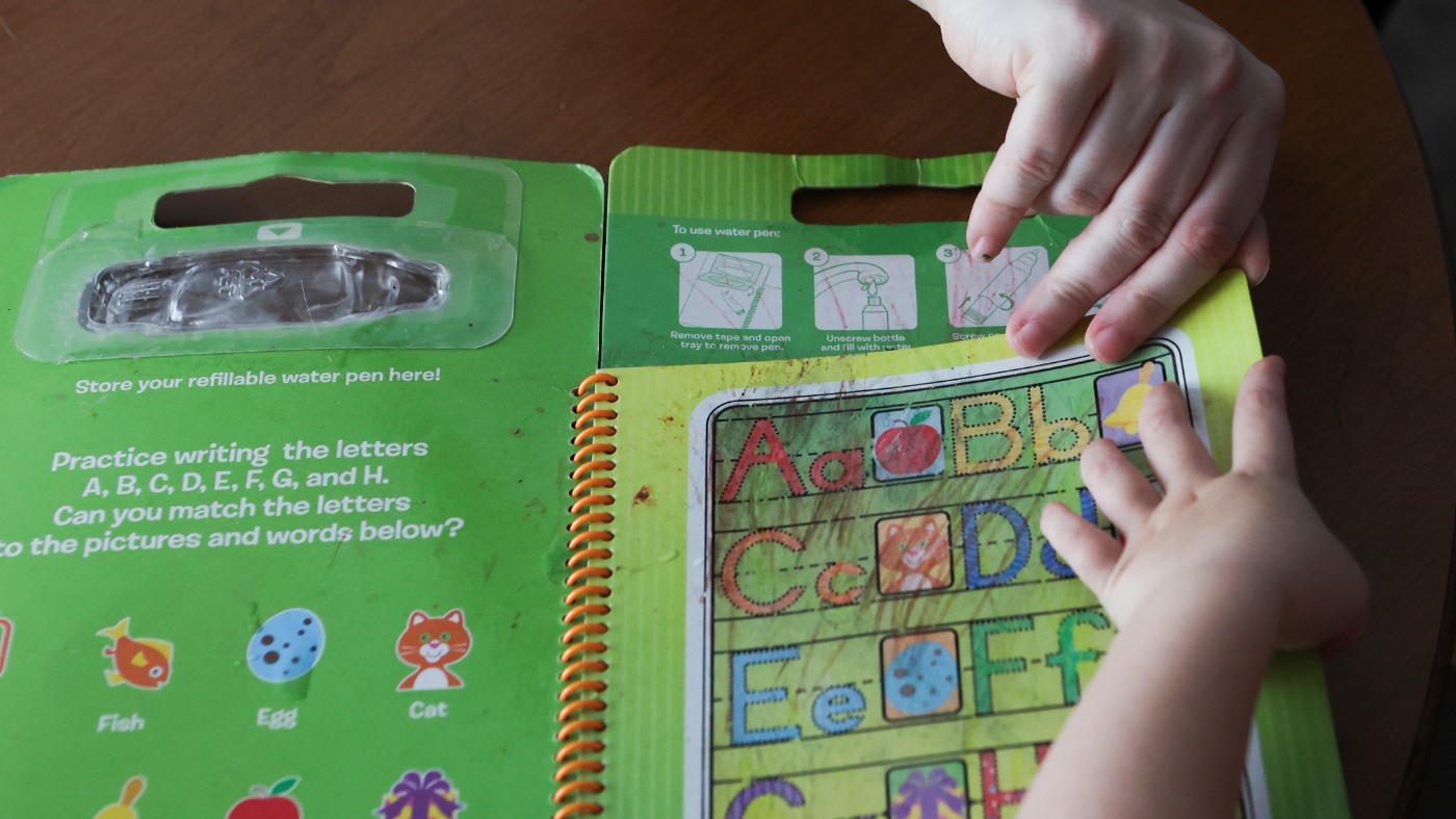 Meygan Maloney looks through a toy with her son Callum Wilson, 3, Aug. 28, 2026, at their home in Hartford City, Ind.