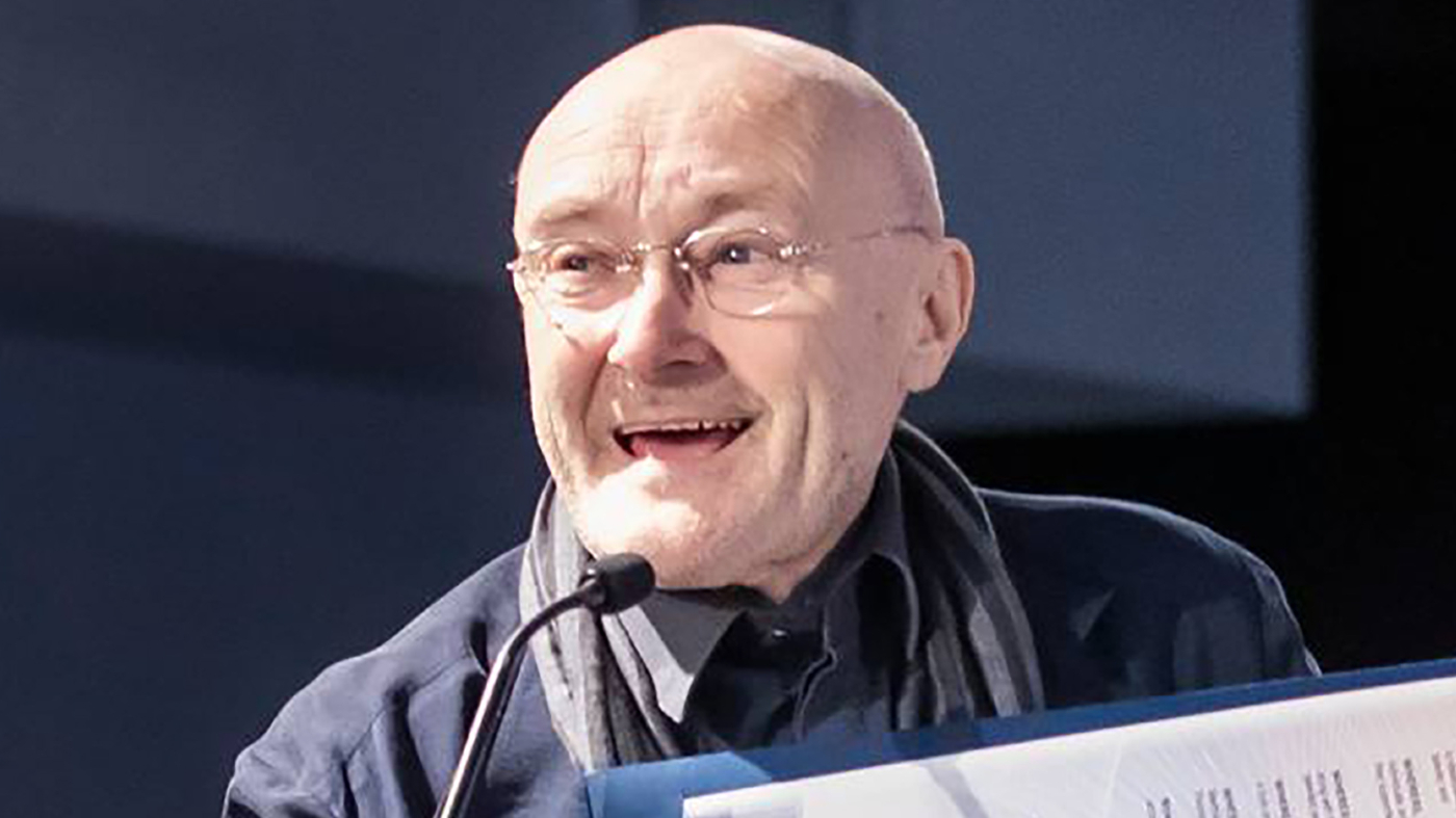 FILE – Phil Collins speaks at an event in Miami.