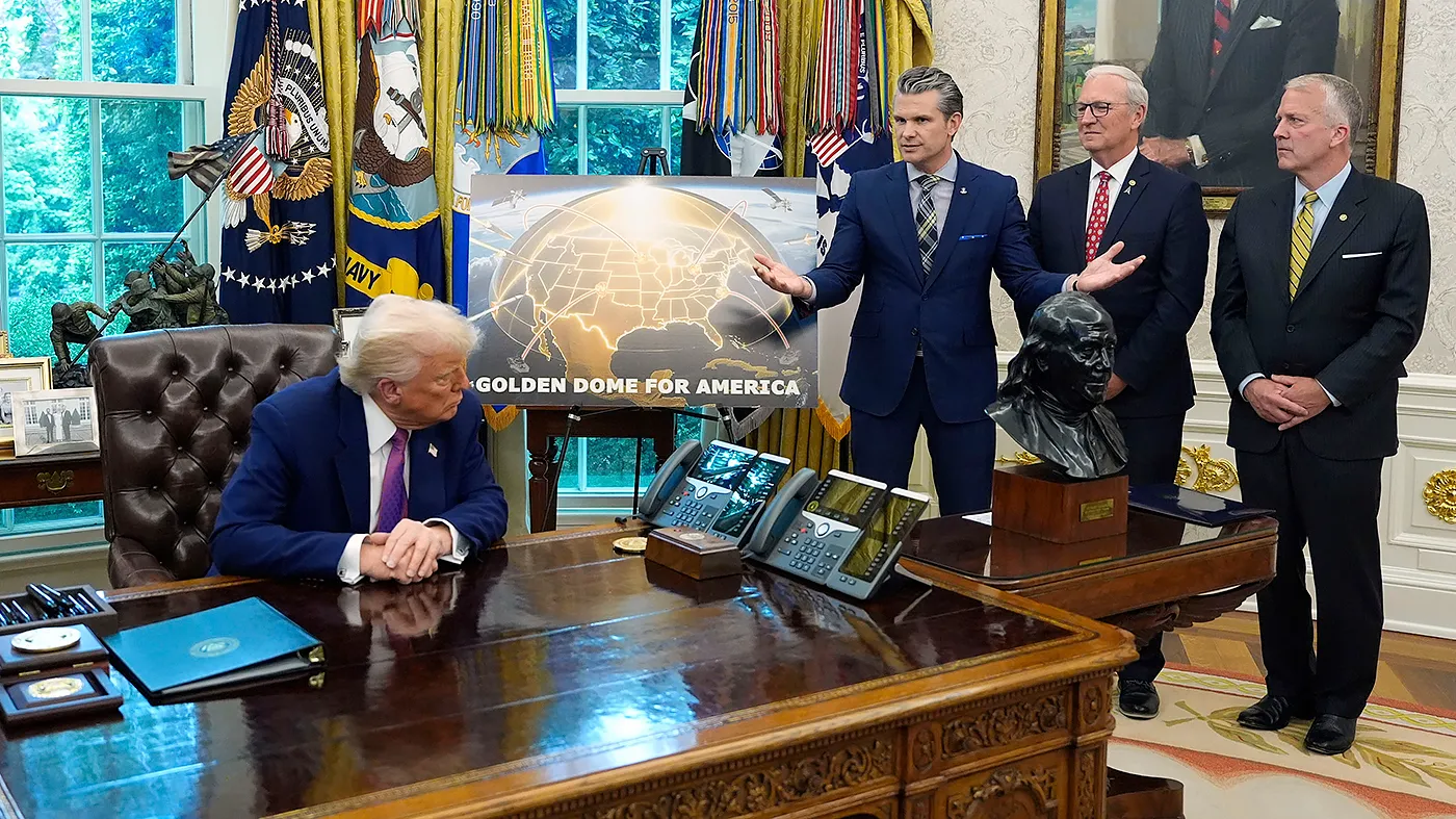 President Trump, Sens. Dan Sullivan (R-Alaska), and Kevin Cramer (R-N.D.) listen as Defense Secretary Pete Hegseth speaks in the Oval Office of the White House, Tuesday, May20, 2025, in Washington, D.C.