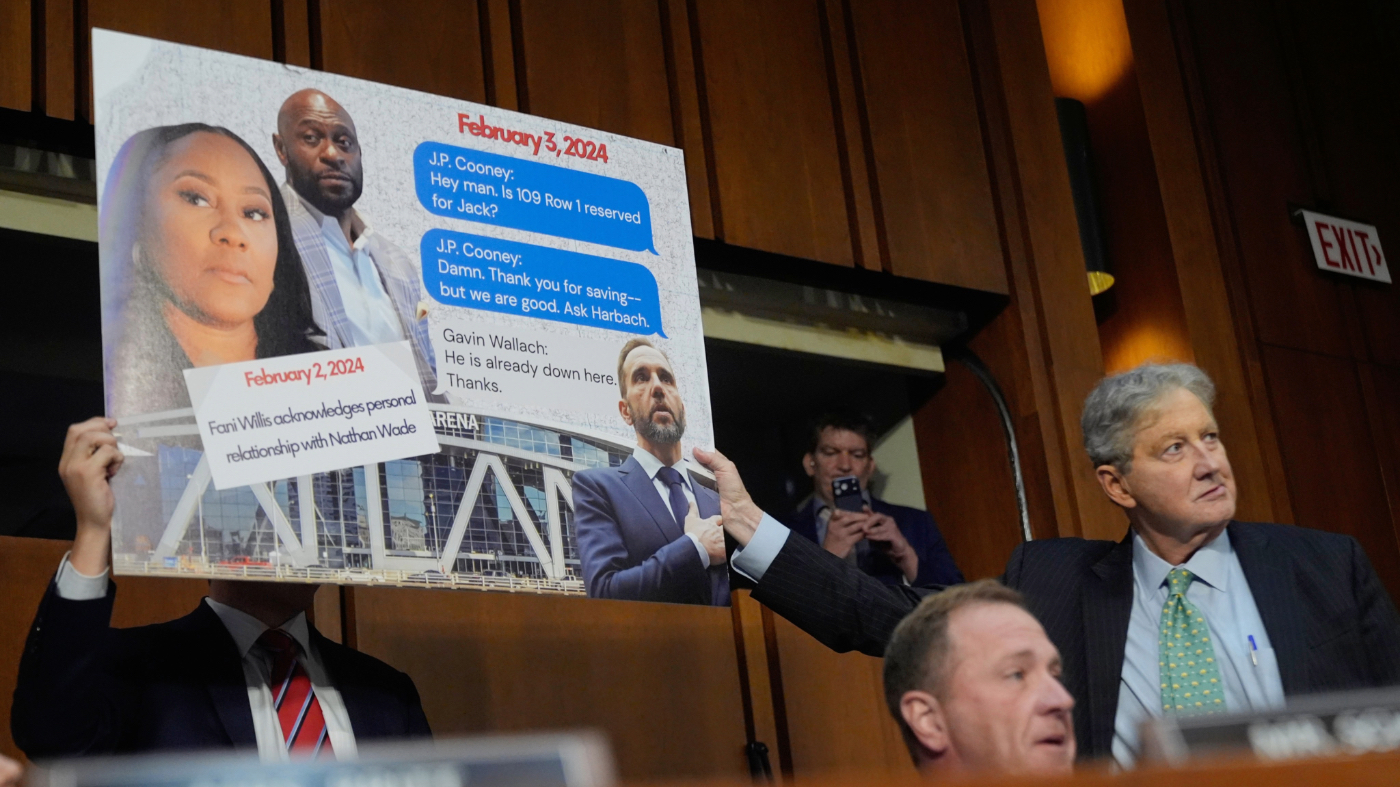 Sen. Eric Schmitt, R-Mo, seated right, with Sen. John Kennedy, R-La., standing right, during a discussion about text messages with former special counsel Jack Smith, as Smith testifies before the Senate Judiciary Committee on Capitol Hill, in Washington, Tuesday, Sept. 29, 2026, as they probe his investigation of President Trump. (AP Photo/Manuel Balce Ceneta)