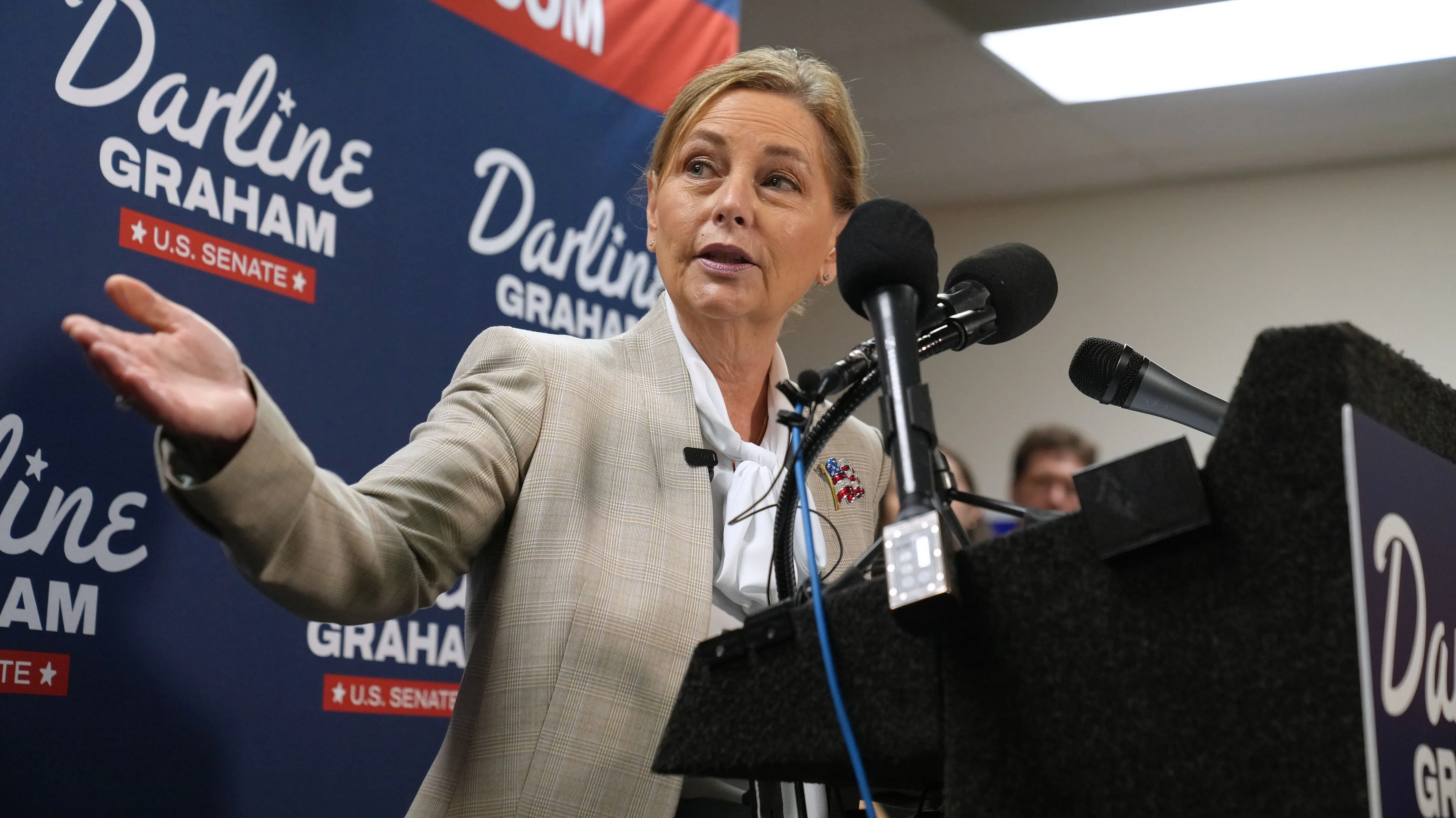 Sen. Darline Graham (R-S.C.) gestures to South Carolina Gov. Henry McMaster (R) at a news conference for her campaign a day ahead of the special GOP Senate runoff to replace her brother, the late Sen. Lindsey Graham (R-S.C.), on Aug. 24, 2026, in Columbia, S.C.
