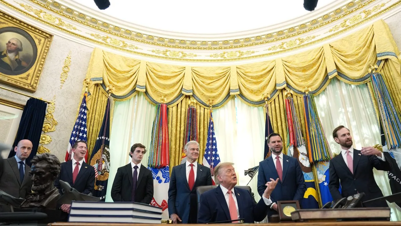 President Donald Trump speaks in the Oval Office of the White House, Tuesday, Oct. 20, 2026, in Washington, as from left, White House deputy chief of staff for policy Stephen Miller, Assistant Attorney General Colin McDonald, Nick Shirley, Centers for Medicare & Medicaid Services administrator Dr. Mehmet Ozm Vice President JD Vance and Andrew Ferguson, chairman of the Federal Trade Commission listen. (AP Photo/Jacquelyn Martin)