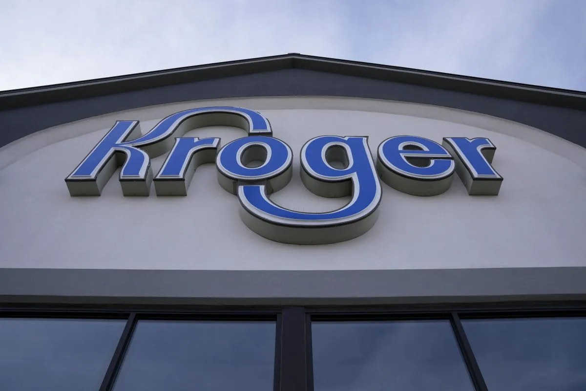 FILE – A sign is affixed to the exterior of a Kroger grocery store in Monroe, Ohio, in this undated photo. (AP Photo/Jeff Dean, File)