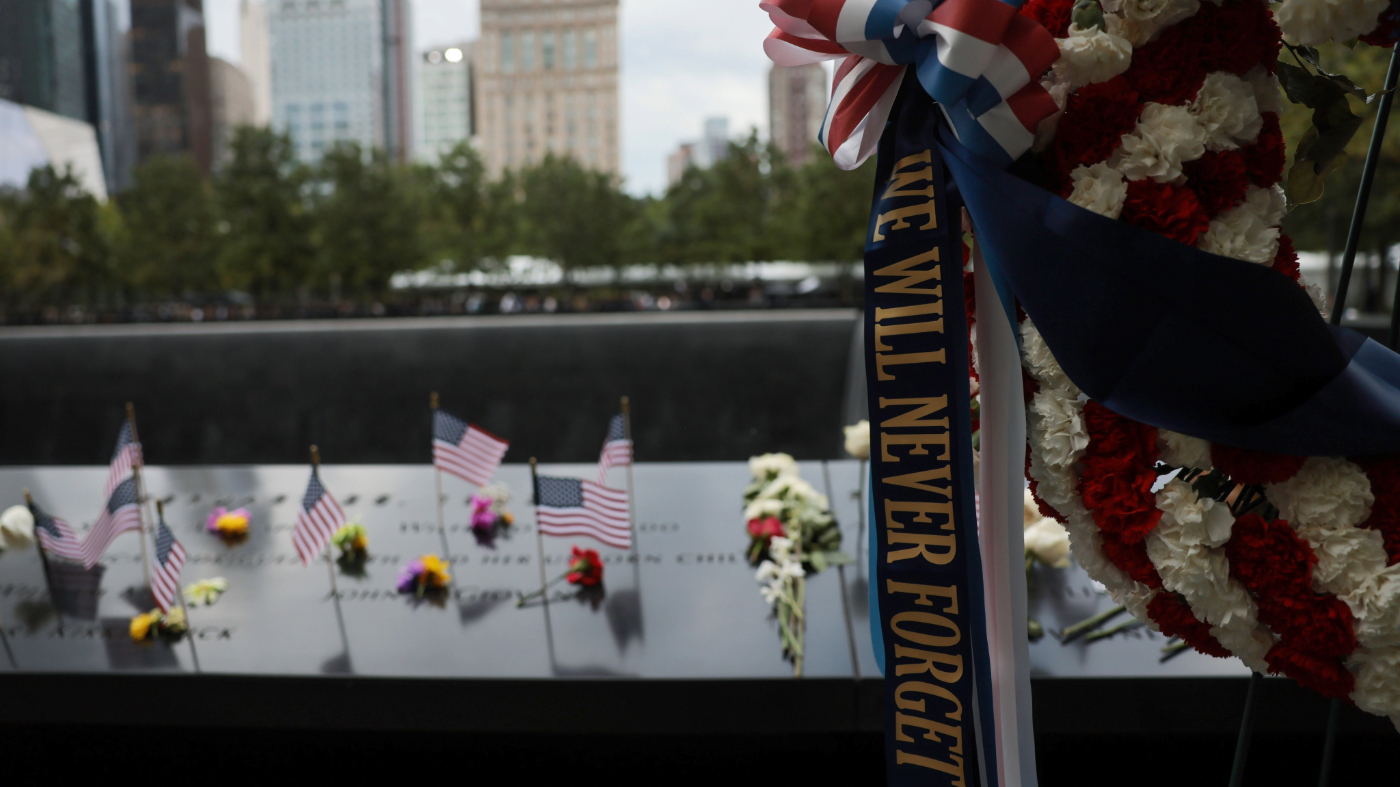 Flowers and flags are left at the memorial before ahead of a ceremony commemorating the 25th anniversary of the Sept. 11, 2001, attacks at the National September 11 Memorial in New York City on Friday, Sept. 11, 2026. (Spencer Platt/Pool Photo via AP)