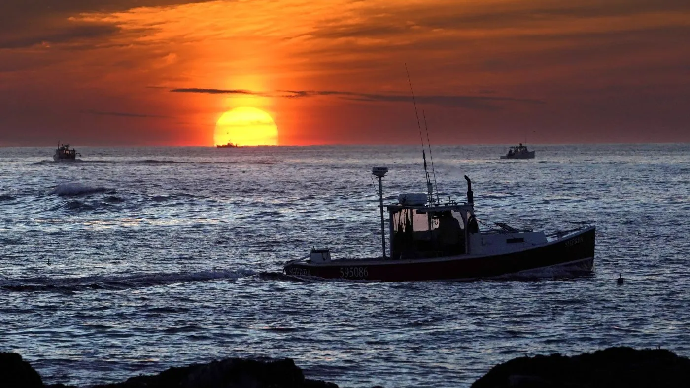 FILE – Lobster fishermen work at sunrise, Thursday, Sept. 8, 2022, off Kennebunkport, Maine. The waters off New England logged the second-warmest year in their recorded history in 2022, according to researchers. (AP Photo/Robert F. Bukaty, File)