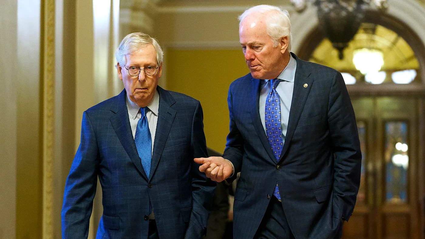 Minority Leader Mitch McConnell (R-Ky.) listens to Sen. John Cornyn (R-Texas) as they head from the Senate Chamber to McConnell’s office on Monday, January 23, 2023.