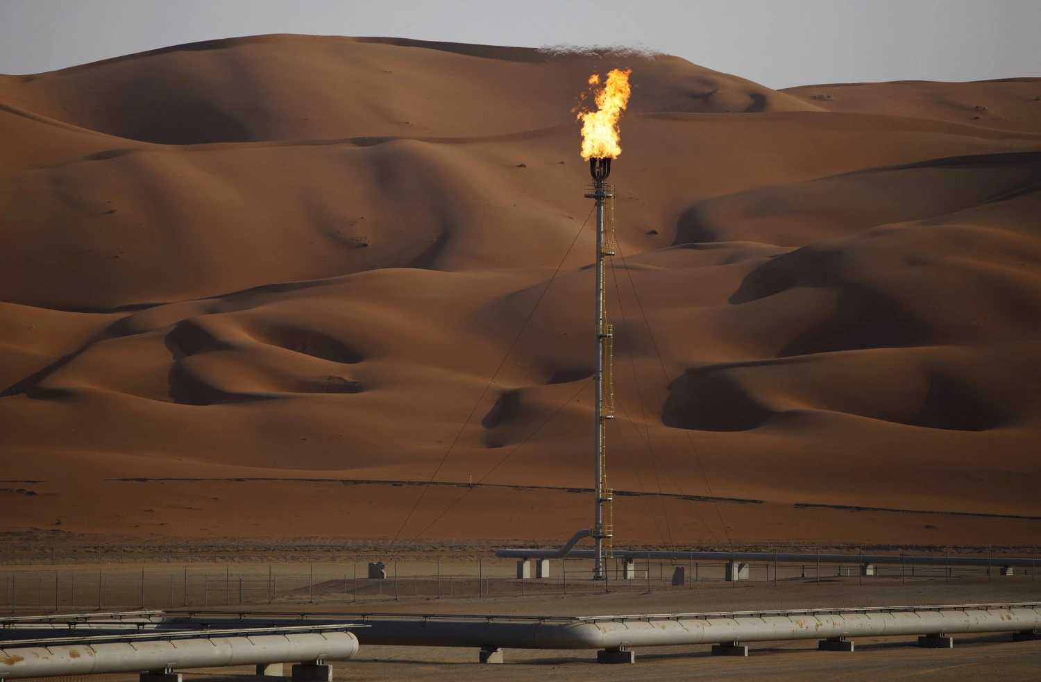 A flame burns off at an oil processing facility in Aramco's oilfield in the Rub' Al-Khali (Empty Quarter) desert in Shaybah, Saudi Arabia.