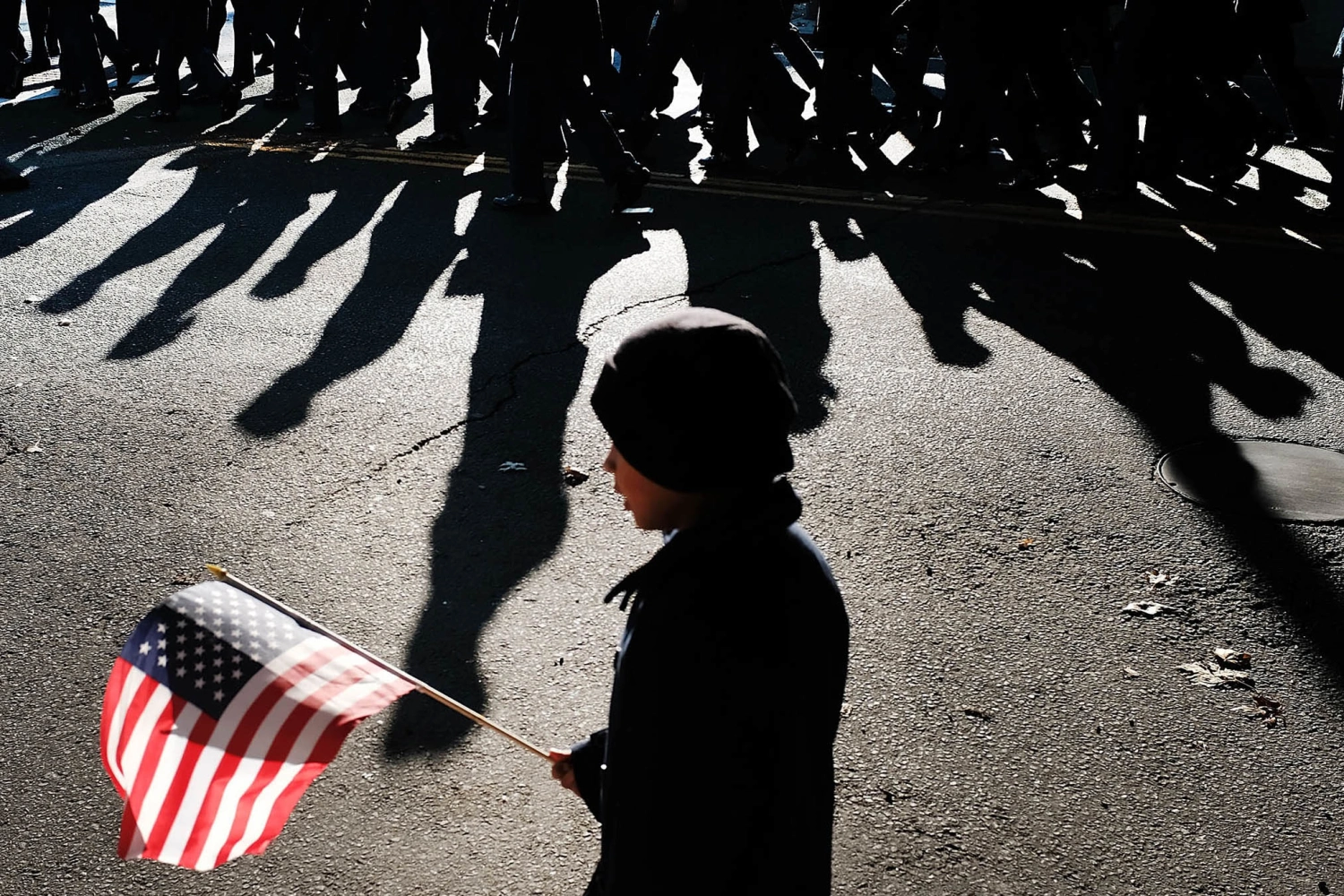 A child holds an American Flag as the Veterans Day Parade passes on November 11, 2018 in Milford, Connecticut.
