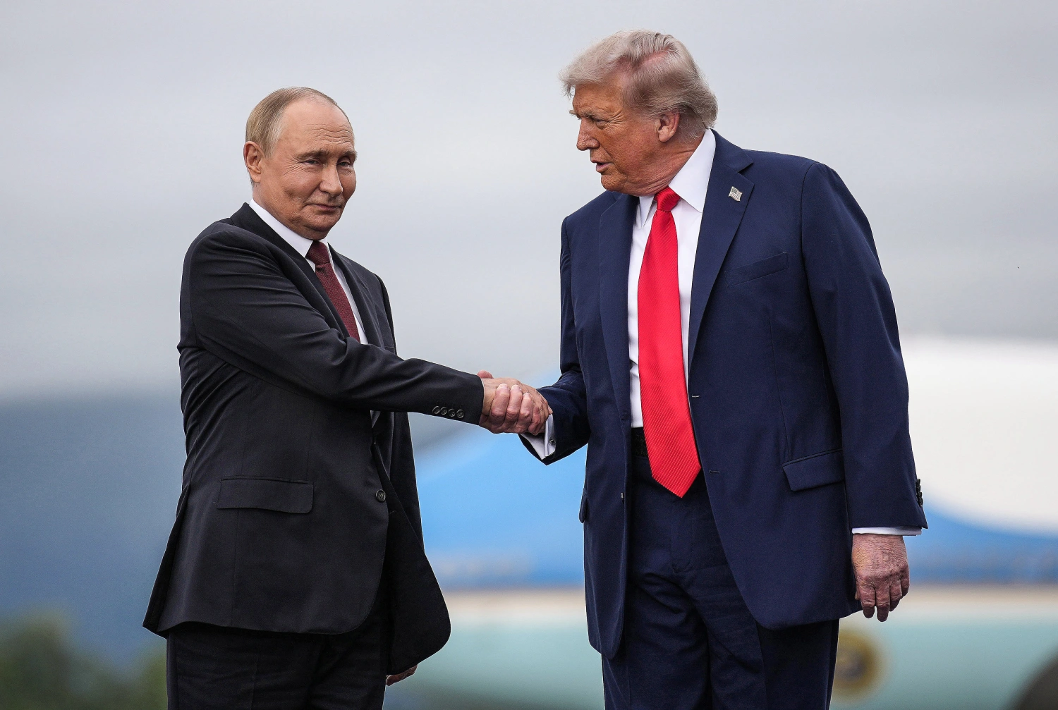 President Donald Trump greets Russian President Vladimir Putin as he arrives at Joint Base Elmendorf-Richardson on Aug. 15, 2025 in Anchorage, Alaska.