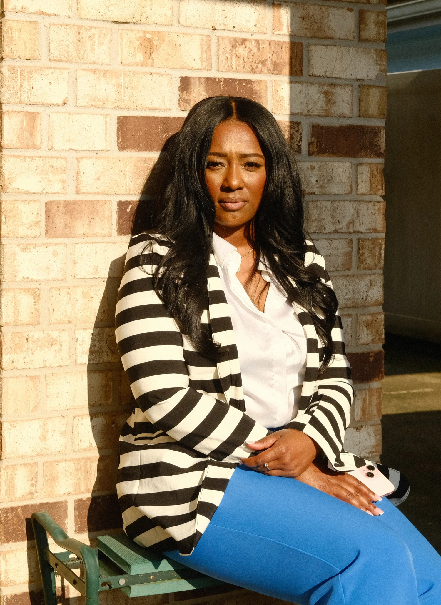 Lakeita Williams outside the home she resided in during the events of Hurricane Katrina, on Aug. 23, 2025. Her mother, who still lives in the home, stayed in a trailer while the home was renovated.