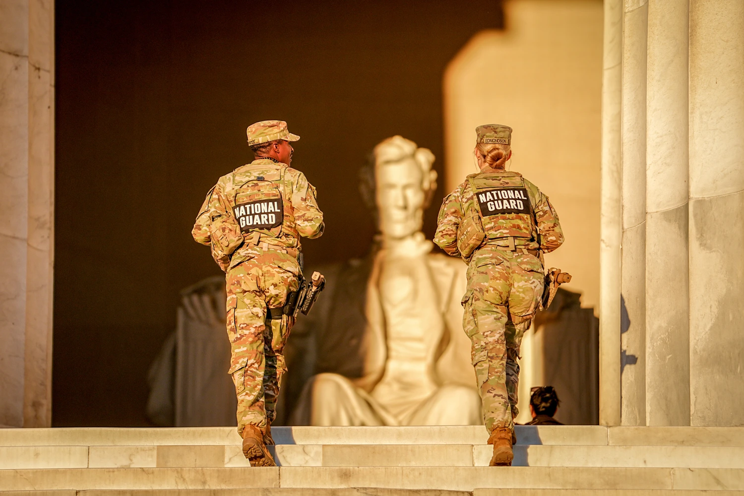 U.S. National Guard soldiers walk up the steps to the Lincoln Memorial in the early morning of Oct. 16, 2025. in Washington DC.