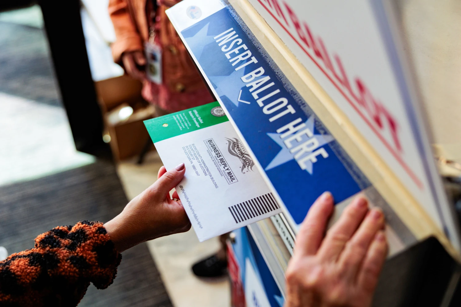 A person drops off a mail-in ballot on Oct. 15, 2024, in Doylestown, Penn.
