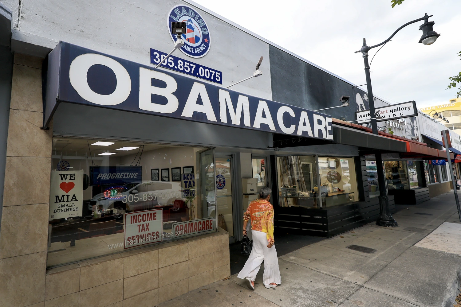 An Obamacare sign is displayed outside an insurance agency on November 12, 2025 in Miami, Florida.