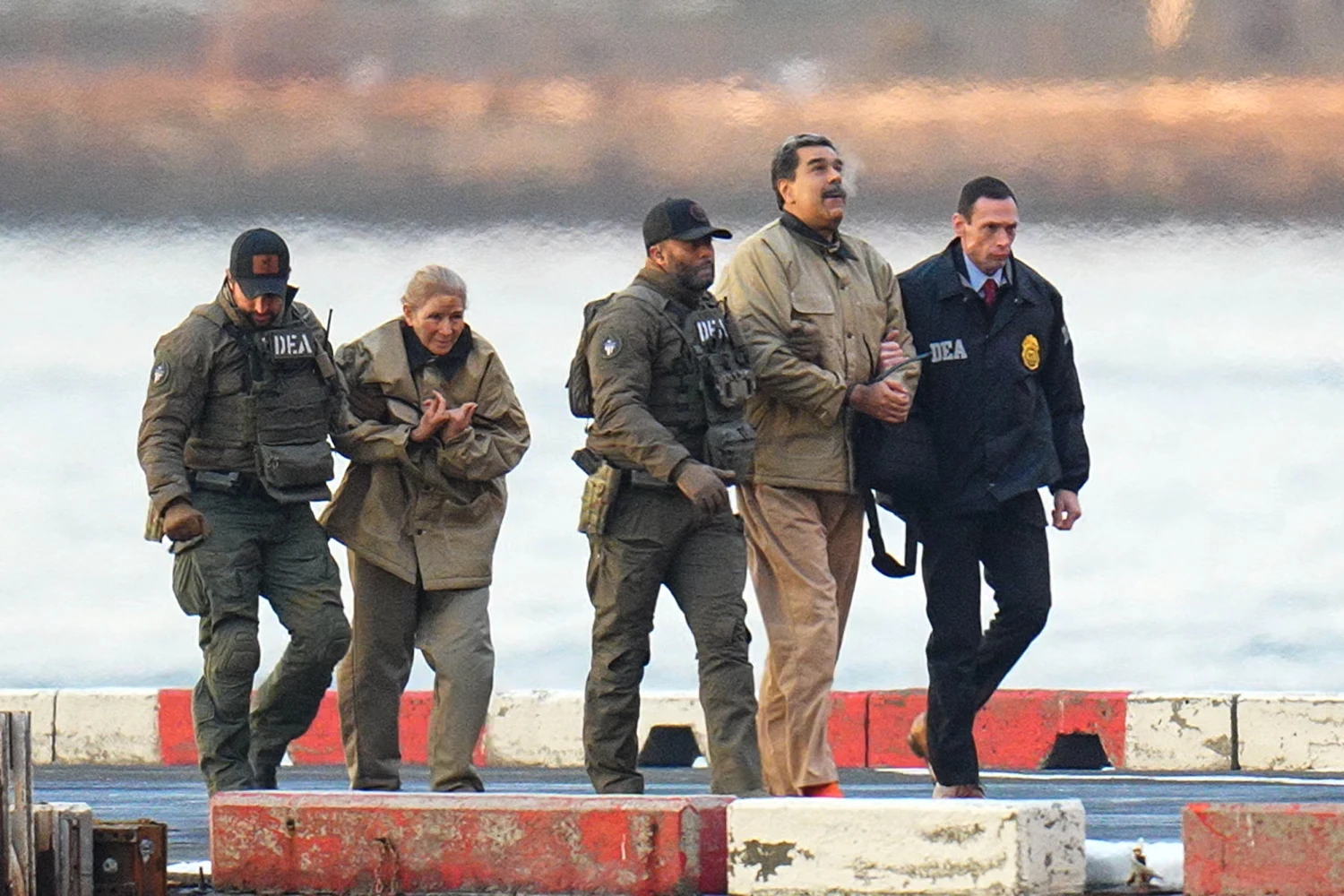 Nicolas Maduro and his wife, Cilia Flores, in handcuffs after landing at a Manhattan helipad, escorted by heavily armed Federal agents as they make their way into an armored car en route to a Federal courthouse in Manhattan on Jan. 5, 2026 in New York.