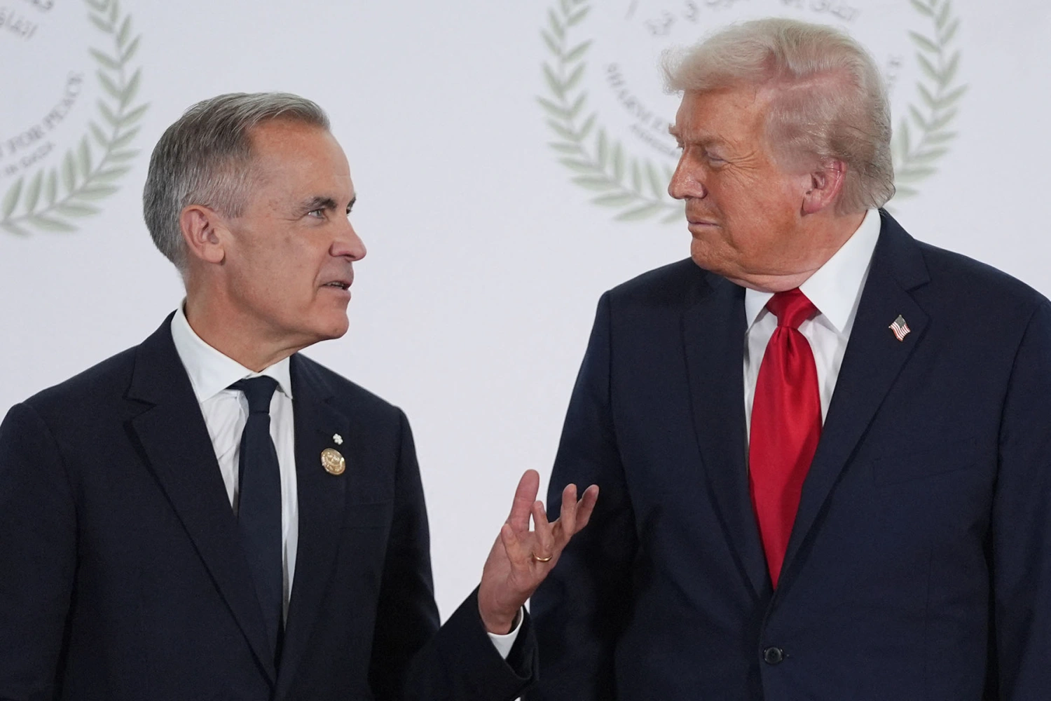 President Donald Trump talks with Canada's Prime Minister Mark Carney during a summit in Sharm el-Sheikh, Egypt on October 13, 2025.