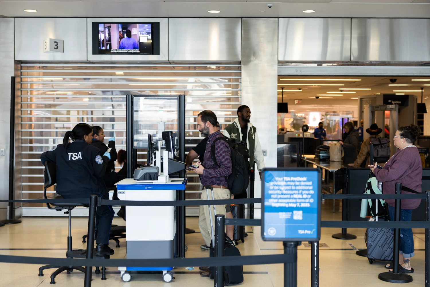 Travelers wait in line at a Transportation Security Administration (TSA) checkpoint at Philadelphia International Airport (PHL) in October 2025 in Philadelphia.
