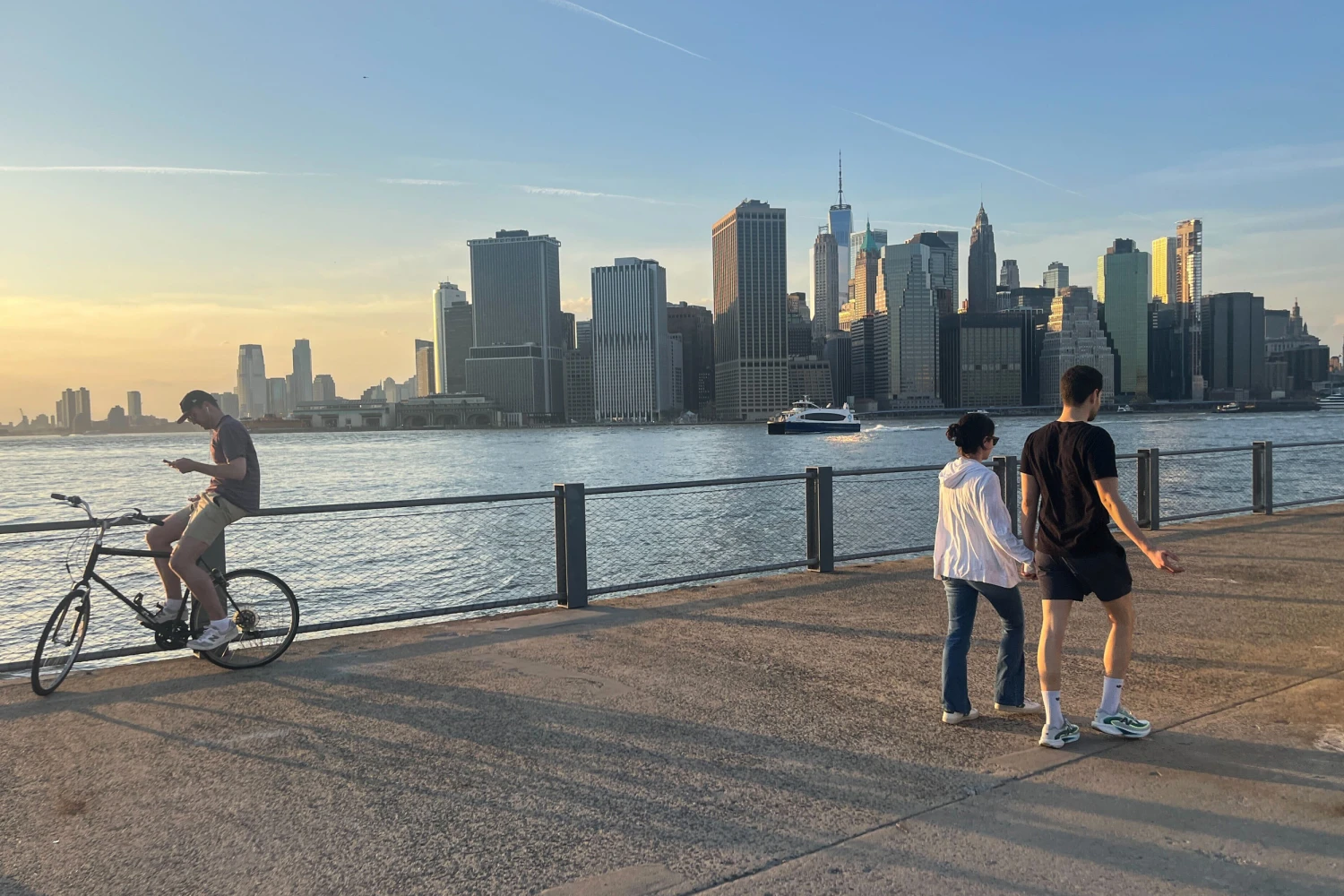 People enjoy the weather Tuesday in Brooklyn Bridge Park in New York.