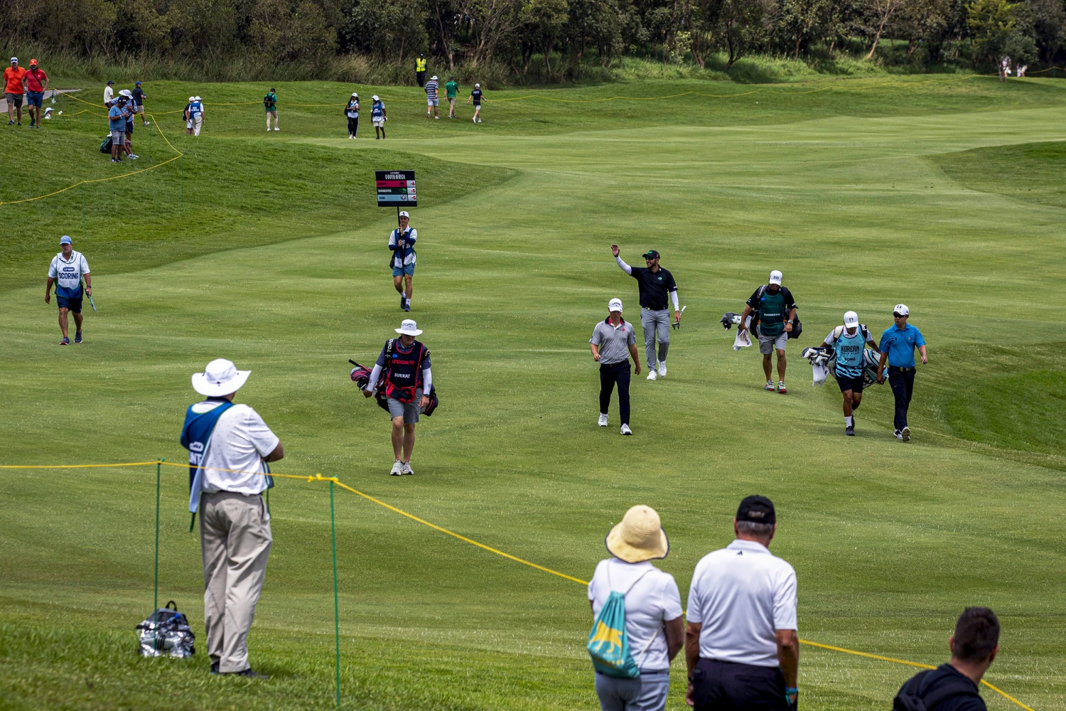 Dean Burmester of Southern Guards GC greets fans before playing his 3rd shot on 12th hole during day two of LIV Golf South Africa at The Club at Steyn City on March 20, 2026 in Johannesburg.