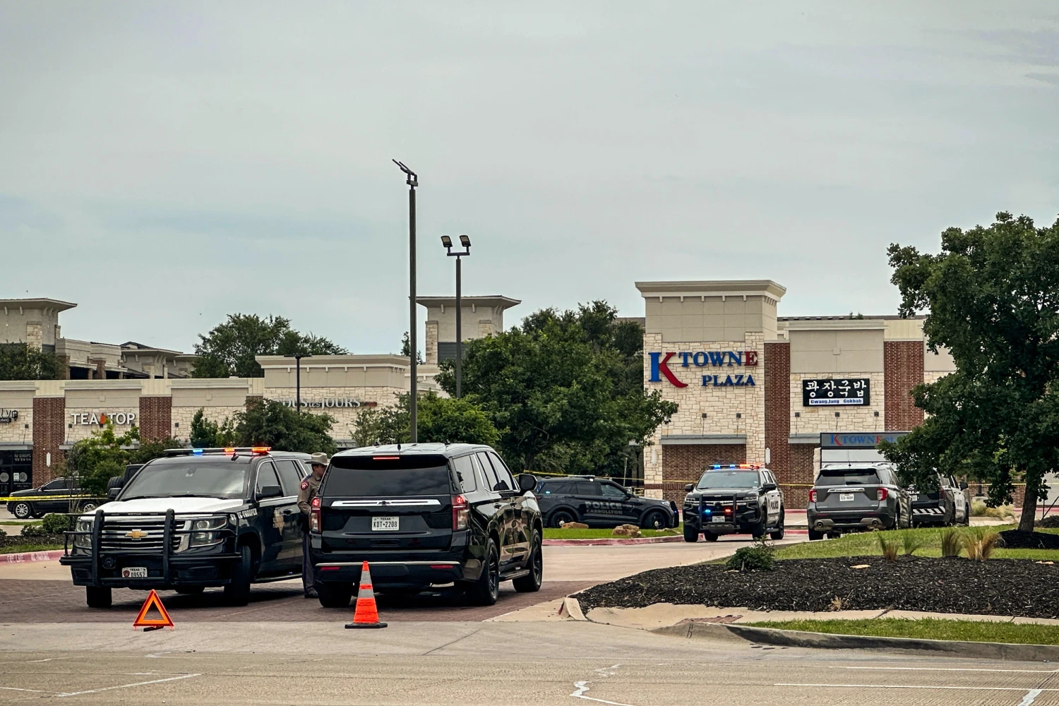 Law enforcement responds to the scene of a shooting on May 5, 2026, at K Towne Plaza in Carrollton, Texas. 