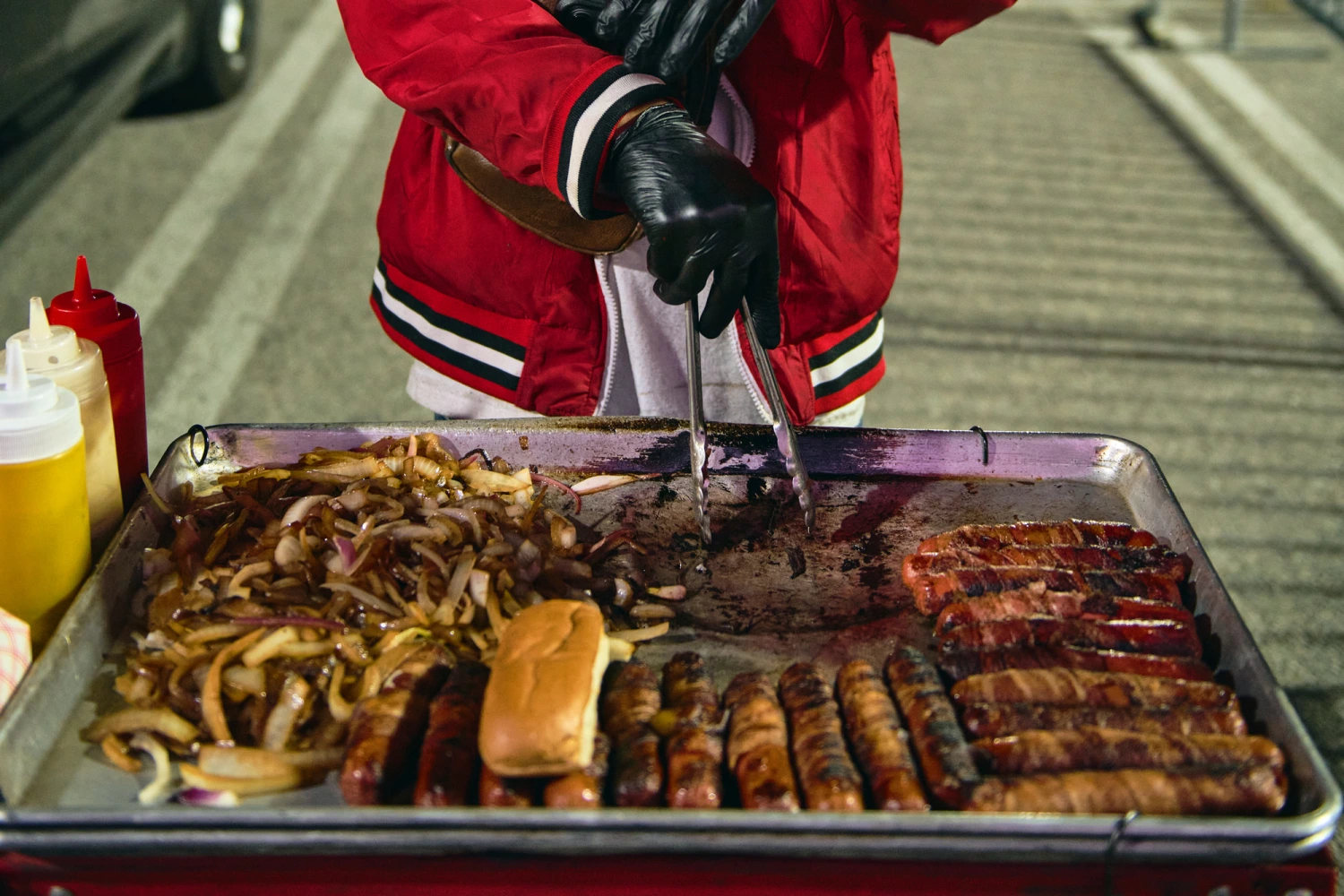 Vendor Henrry Josue sells hot dogs outside of the Charlie Puth concert at the Kia Forum in Inglewood, Calif., on April 29 2026.