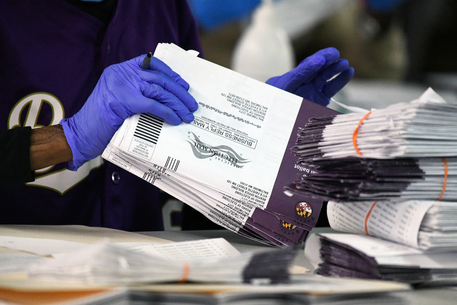 Canvassers open and review mail-in and absentee ballots for the 2024 General Election at the Baltimore City Board of Elections warehouse on Nov. 7, 2024, in Baltimore.